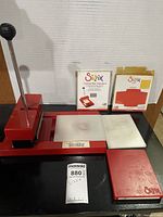 Overall view of Sizzix machine with pads and packaged accessories