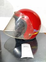 Right side view of red helmet with Thunder decal and visor
