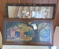 Both framed prints leaning against wall