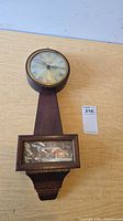 Full view of Verichron banjo-style wall clock hanging on wall