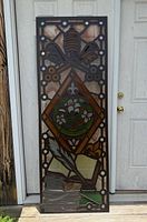 Full view of stained glass panel standing vertically