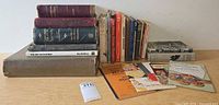 Group shot showing stacked hardcovers, standing books, cookbooks and magazines