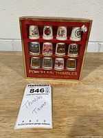 Front of boxed set showing all 12 porcelain thimbles