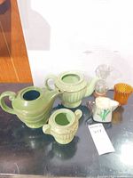 Group shot of all pottery and glass pieces on table