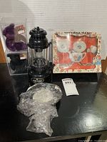 Overall lot showing lantern, tea set box, bubble-wrapped doll, two cased bears