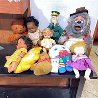 Overall lot on shelves showing all nine dolls and plush items