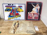 Front view of Street Rods, Dr Pepper, and Spencer Clothiers signs