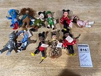 Group shot of ten miniature dolls displaying overall lot