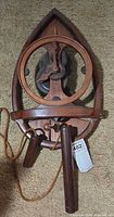 Front view showing full wood frame, open face and mechanisms