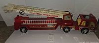 Full view of Nylint pressed steel fire truck with extended ladder