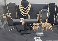 Group view of all faux pearl necklaces, bracelet, and earrings
