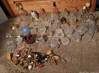 Full lot showing perfume bottles and loose hardware on carpet