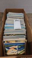 Box filled with large stack of postcards
