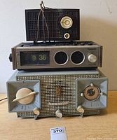 All three radios stacked showing front panels and overall condition