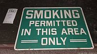 Full view of metal sign showing wording and color