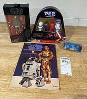 Grouped shot: boxed Rey figure, Pez set, storybook, micro machine