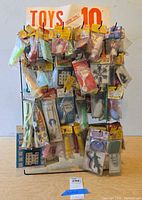 full view of wire rack filled with sealed toy packages and 10¢ header card