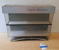 Front view showing Timex branding, clear acrylic panels and interior shelf