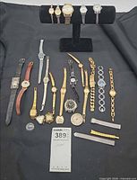 Full lot overview showing all wristwatches, loose watch heads, bands and crystal