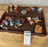 All items displayed in tray showing variety of vintage wind-up toys