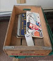Wooden Pepsi-Cola crate containing stacked license plates