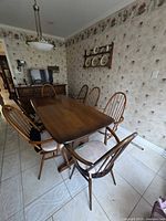 View showing the dining table and six chairs arranged around it in a dining room.