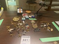 Overview of various airplane and McDonnell Douglas related lapel pins, cufflinks, tie clip, model airplane, and golfers score caddy