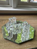 Octagonal beveled mirror with train pieces displayed on top