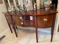 Front three-quarter view of buffet with decorative figurines (not included) on top