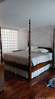 Full bed from side showing four posts and mattress
