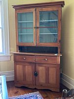 Full front view of assembled two-piece cabinet showing overall wear and finish.