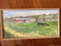 Full view of the framed oil painting showing two horses grazing in a field with a barn in the background
