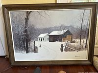 Full view of oil painting in wood frame showing snowy rural winter scene with house and barn