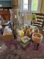 Overview of various candles, light bulbs, candle holders, and decorative items on table