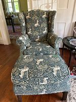 Front view of wingback chair and ottoman showing overall style and pattern