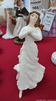 Front view of the Royal Doulton porcelain figurine depicting a woman in a flowing dress.