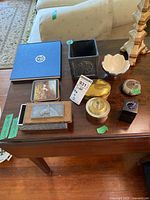 Overview of all items on table showing trinket boxes, dish, coasters, paper clip holder, and photo book.