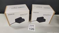Two boxed Iselector Desktop Chargers shown side by side on a white surface.