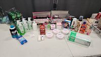 Wide view of all items in lot including beauty creams, shampoos, lotions, razor blades, and other health and skin care products.