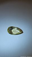 Photo of pear cut lemon citrine gemstone showing shape, cut, and clarity.