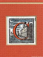 Close-up of the hand-coloured woodblock showing the historiated letter 'C' with building background in red, blue, black ink.