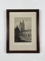 Framed engraving view from the front showing the full framed print with light cream mat and dark wooden frame.