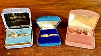 Six vintage 10kt gold filled rings in original blue, pink, and dark ring boxes, showing three pairs of thick and thin bands in various sizes.