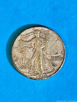 Close-up image of the 1942 Walking Liberty half-dollar coin, showing the front side with Lady Liberty, inscriptions, and year 1942.