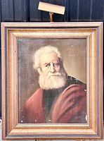 Front view of framed antique oil on canvas painting showing portrait of elderly man with white beard wearing red robe. Visible artist signature A Rodin in lower right corner.