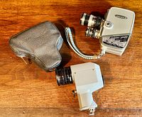 Yashica-8 camera with wrist strap, carrying case and Soligor spot sensor light meter on wooden surface