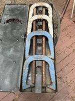 Full view of horseshoes and stakes inside a black plastic case