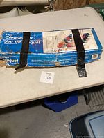 Original box with blue label reading '6 Player Croquet Set, Jeu de Croquet' taped with black tape