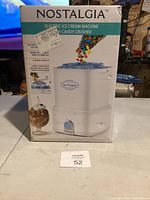 Photo of the front of the box for the Nostalgia electric ice cream machine with candy crusher showing product image and basic features