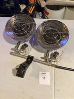 Two propane heater units mounted on metal frame with mounting bracket shown from overhead angle